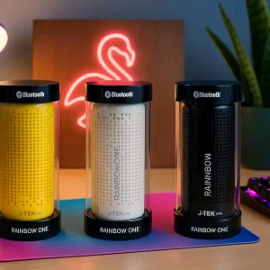 Trois enceintes Bluetooth J-TEK One Rainbow One alignées, modèles jaune, blanc et noir.